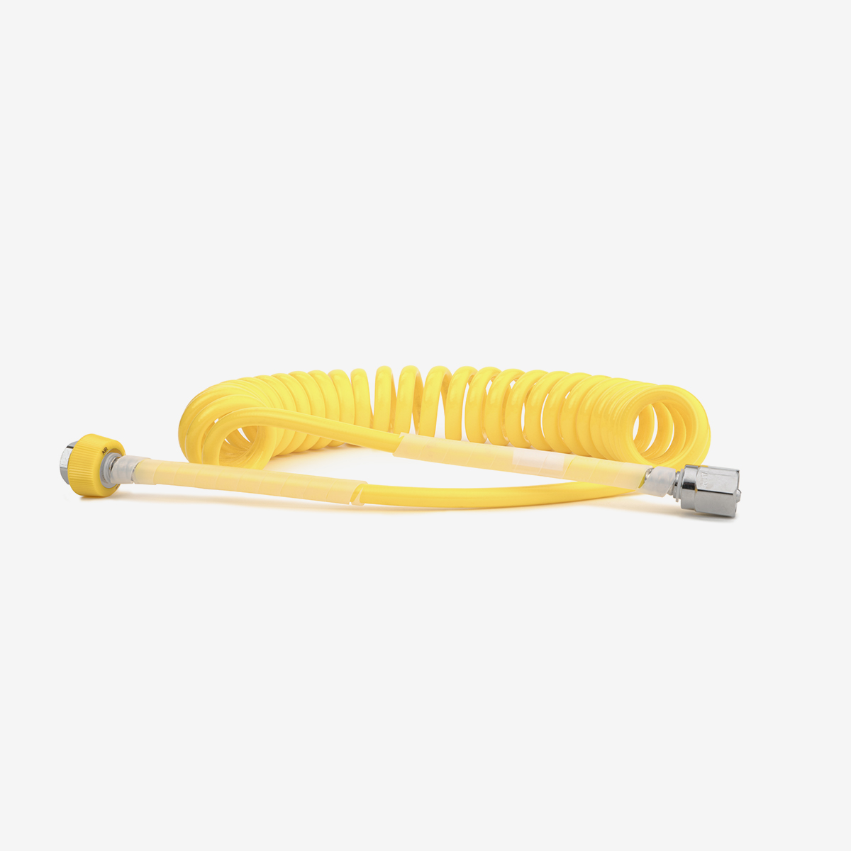 Yellow coiled medical air hose on white background