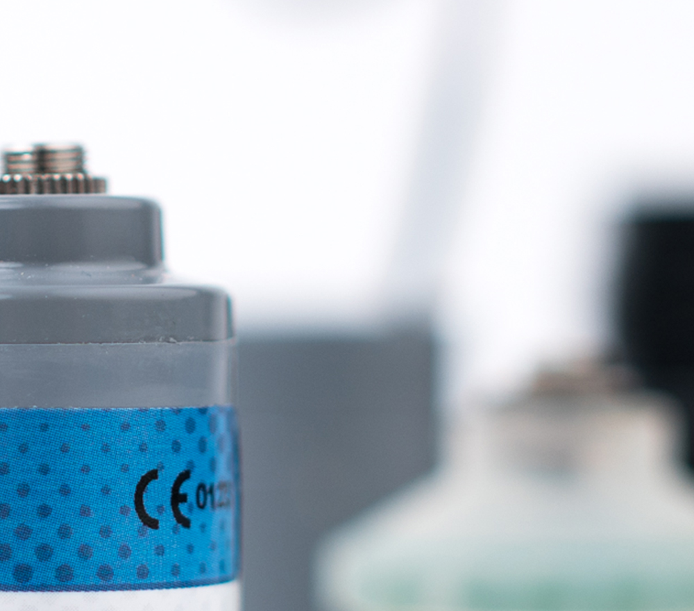 Artistic photo of the top of an oxygen sensor with a shallow depth of field and blurred background